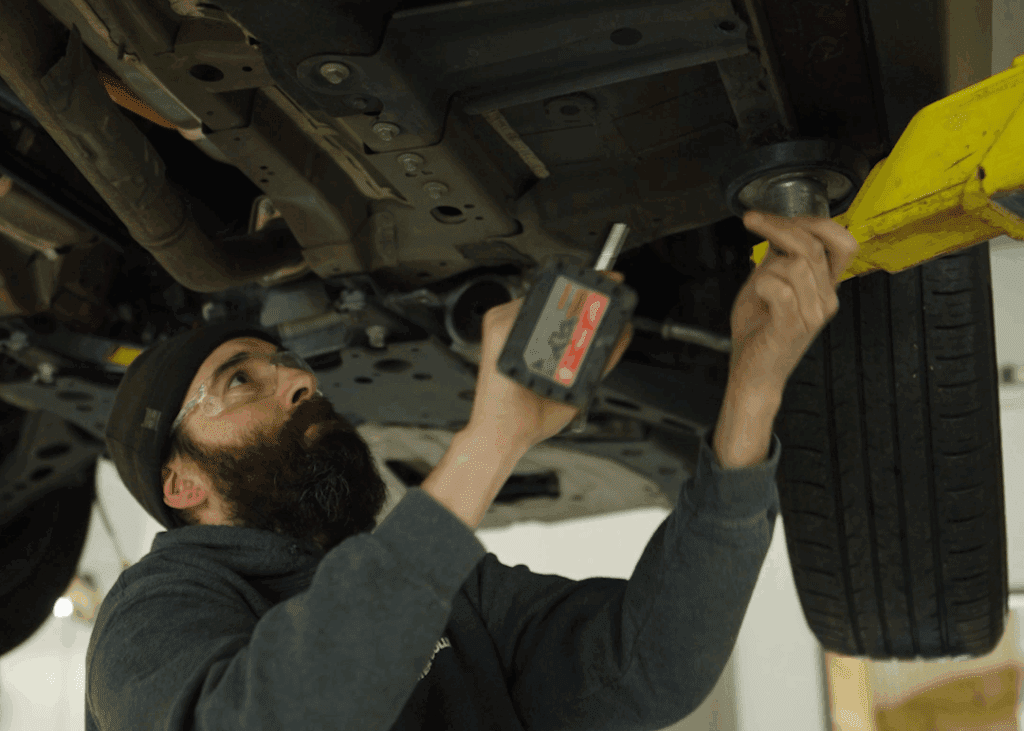 Mechanic working under a vehicle.